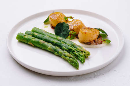 Freshly sauteed scallops with green asparagusの写真素材