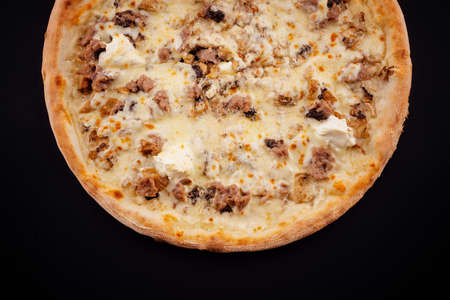 Tasty pizza with fresh ingredients on blackの写真素材