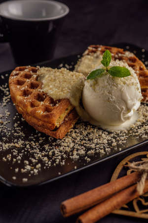 Ice cream with belgian waffles, fresh mint, vanila topping and cinnamonの写真素材