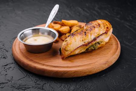 Fried chicken served with sauce and garnish on wooden boardの写真素材