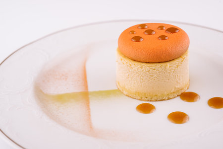 Piece of delicious cake with caramel on white plateの写真素材