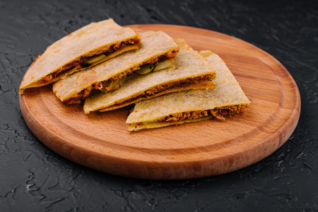 Mexican quesadilla with chicken on wooden table.の写真素材