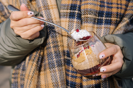 woman hands holding glass with chia pudding