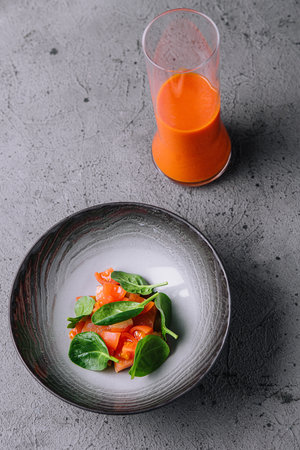 carrot juice with tomato and basil saladの写真素材