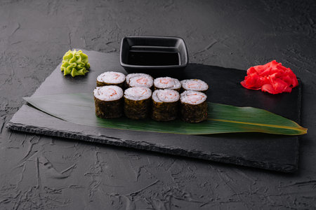 Ebi maki - sushi roll with shrimps on black boardの写真素材