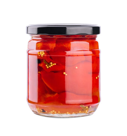 Sweet red peppers in a glass jar isolated on a white backgroundの写真素材