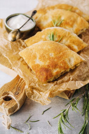 Delicious pies filo pastry with chicken, spinach and feta close-up on the tableの写真素材