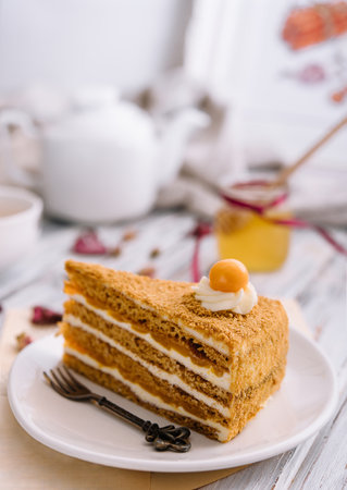 Layered orange cheesecake on plate on wooden tableの写真素材