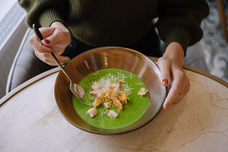 Broccoli green cream soup with shrimpsの写真素材