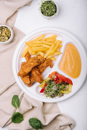 Chicken nuggets with french fries and mustard sauceの写真素材