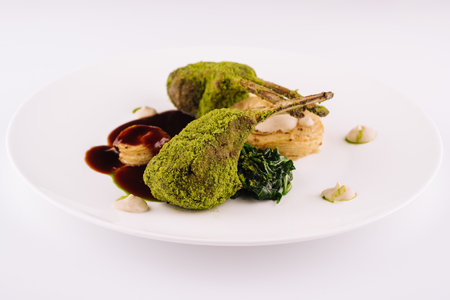 Grilled rack of lamb with mint and pistachio on plateの写真素材