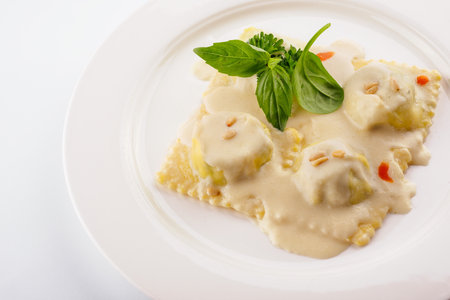 Plate of tasty traditional italian ravioli with basilの写真素材
