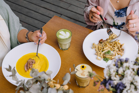 two girls have lunch in a restaurantの写真素材