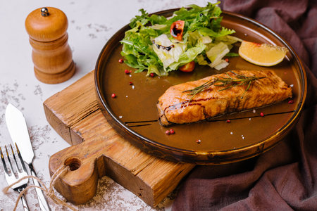 Grilled salmon and vegetables on plateの写真素材