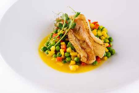 Plate with tasty baked cod fillet with vegetables