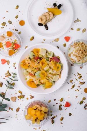 plate of fresh fruit salad and ice cream with jelly and nutsの写真素材