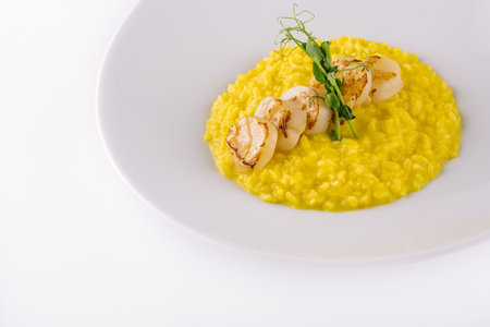 fried scallops with corn on white plateの写真素材