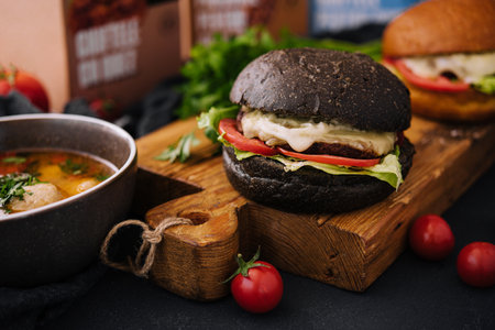 Modern black burger on wooden boardの写真素材