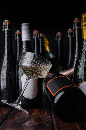 different bottles of champagne with a glass of white champagneの写真素材