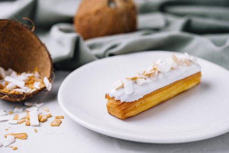 french eclair with coconut on plateの写真素材
