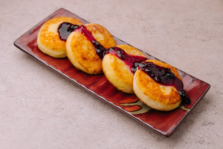 Fritters of cottage cheese with blueberries jam
