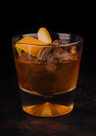 Old-fashioned cocktail with ice and orange peel