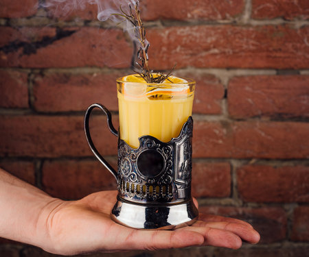 Summer refreshing orange cocktail with rosemary and fresh fruitsの写真素材