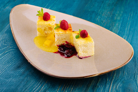 Piece of cottage cheese casserole with cherry jam