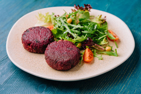 Beet cutlets with couscous and arugulaの写真素材