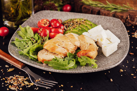 chicken breast with avocado salad and arugulaの写真素材