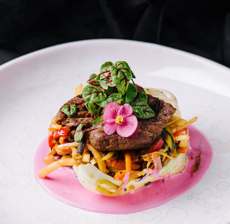 Beef medallions with fresh salad on plateの写真素材