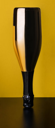 elegant bottle of champagne on a yellow-black backgroundの写真素材