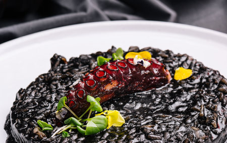 Cooked octopus and black rice in plateの写真素材