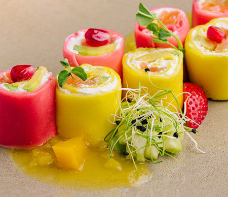 Sweet sushi with pineaplle, strawberries with pomegranateの写真素材