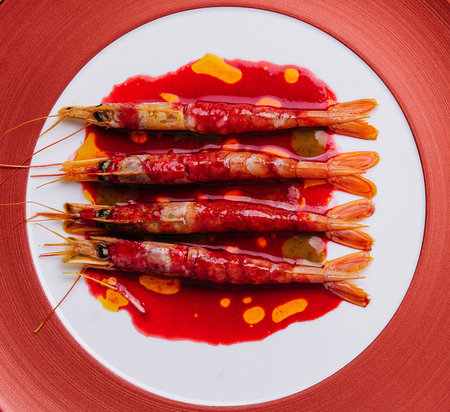 Grilled tiger prawns on a ceramic plate, top viewの写真素材