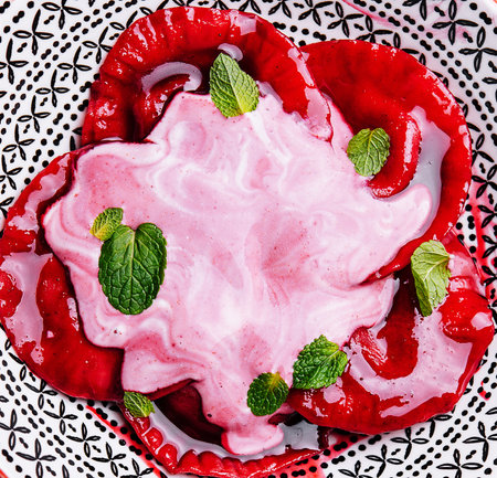 Vegan red ravioli with beetroot on a plate in cream sauceの写真素材