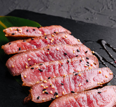 Sliced medium rare roasted beef meat piecesの写真素材