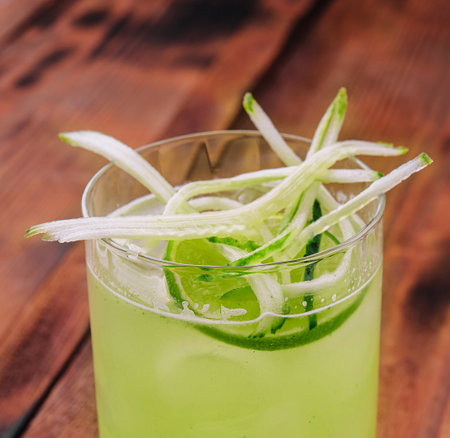 Glass of fresh mojito on wooden tableの写真素材
