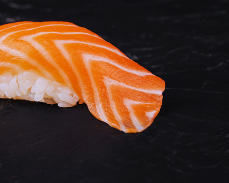 Salmon nigiri sushi on black stoneの写真素材