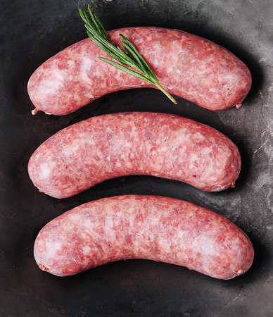 raw romanian sausages in a frying panの写真素材