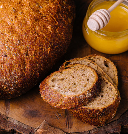 bread with honey on a wooden stumpの写真素材