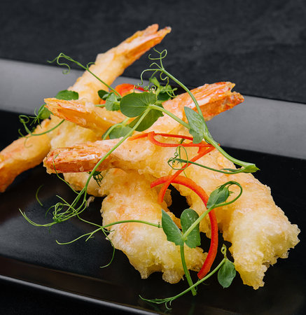Fried shrimps tempura on black stone plateの写真素材