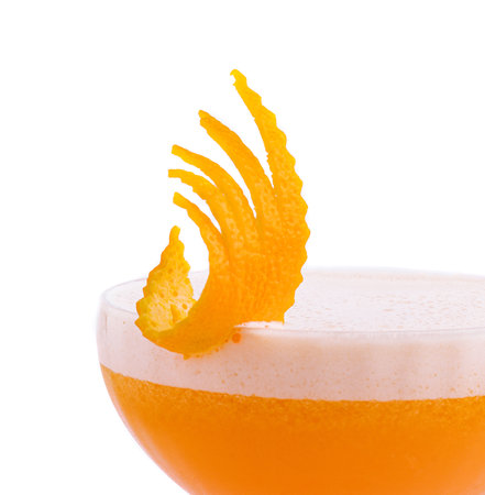 Glass of Ruby Cocktail garnished with orange zestの写真素材