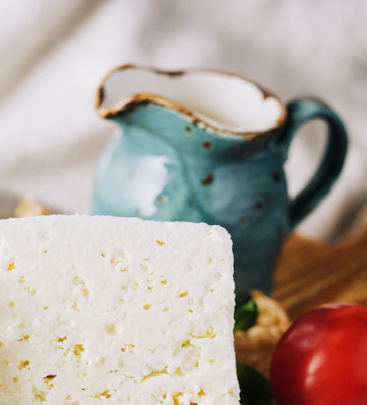 Homemade greek cheese feta on wooden cutting boardの写真素材