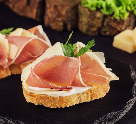 bruschetta set with parma ham and parmesan cheeseの写真素材