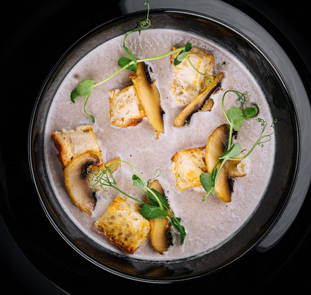Creamy mushroom soup with champignons top viewの写真素材