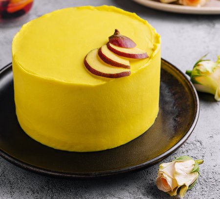 yellow cake with tea and rosesの写真素材