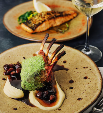 Rack of lamb in breaded pistachio nuts, dark sauce and herbsの写真素材