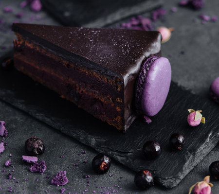 chocolate cake with macaroons on black boardの写真素材