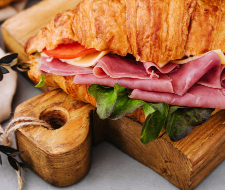 Delicious croissant sandwich on wooden boardの写真素材